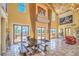 Spacious foyer with travertine flooring, large windows, and rustic wood table at 10 Via Visione # 103, Henderson, NV 89011