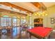 Community game room showcasing a pool table, hardwood floors, and access to outdoor amenities at 10 Via Visione # 103, Henderson, NV 89011