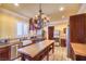 Charming kitchen featuring dark cabinets, a farmhouse sink, and stainless steel appliances at 10 Via Visione # 103, Henderson, NV 89011