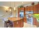 Well-lit kitchen boasting stainless steel appliances, a center island, and modern lighting at 10 Via Visione # 103, Henderson, NV 89011