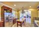 Bright kitchen featuring stainless steel appliances, wood cabinets, an island, and views into the living room at 10 Via Visione # 103, Henderson, NV 89011