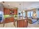 Open-concept kitchen featuring stainless steel appliances and granite counters at 10 Via Visione # 103, Henderson, NV 89011