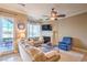 Cozy living room featuring a fireplace, ceiling fan, and access to outdoor patio at 10 Via Visione # 103, Henderson, NV 89011
