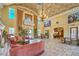Expansive living room featuring travertine flooring, high ceilings, and comfortable seating at 10 Via Visione # 103, Henderson, NV 89011