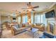 Open-concept living room with fireplace, ceiling fan, and dining area at 10 Via Visione # 103, Henderson, NV 89011