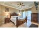 Elegant bedroom with tray ceilings, a decorative bed frame and private balcony access at 10 Via Visione # 103, Henderson, NV 89011