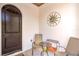 Cozy patio with a decorative sunburst wall hanging, chairs, and a small table at 10 Via Visione # 103, Henderson, NV 89011
