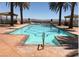 Relaxing pool area features palm trees and cabanas with mountain views at 10 Via Visione # 103, Henderson, NV 89011