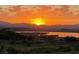 Scenic view of a golden sunset over a lake, with mountains in the distance and a golf course in view at 10 Via Visione # 103, Henderson, NV 89011