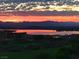 Scenic view of a colorful sunset over a lake, with mountains in the distance and a golf course in view at 10 Via Visione # 103, Henderson, NV 89011