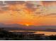 Scenic view of a golden sunset over a lake, with mountains in the distance and palm trees in view at 10 Via Visione # 103, Henderson, NV 89011