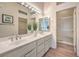 Spacious bathroom boasts a double vanity, well-lit mirrors, and a glass-enclosed shower at 10057 Bundella Dr, Las Vegas, NV 89134