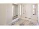 Bright entryway with neutral tile flooring, a decorative front door, and an adjacent hallway at 10057 Bundella Dr, Las Vegas, NV 89134