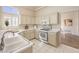 Well-lit kitchen with plentiful counter space, white appliances, and stylish tile flooring at 10057 Bundella Dr, Las Vegas, NV 89134