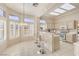 Bright kitchen with white cabinets, a breakfast bar, and ample natural light from surrounding windows at 10057 Bundella Dr, Las Vegas, NV 89134