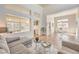 Bright and airy living room with high ceilings, wood floors, and a view of the dining area at 10057 Bundella Dr, Las Vegas, NV 89134