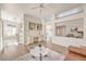 Open-concept living room with wood floors, built-in shelving, and a view into the kitchen at 10057 Bundella Dr, Las Vegas, NV 89134