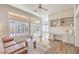Bright sitting room with built-in shelving, plantation shutters, and wood floors with ample natural light at 10057 Bundella Dr, Las Vegas, NV 89134