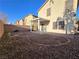 An open backyard with a covered patio and block wall offer privacy and potential for landscaping at 11763 Village Arbor St, Las Vegas, NV 89183