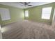 This bedroom has neutral carpet and three windows to allow natural light at 11763 Village Arbor St, Las Vegas, NV 89183