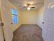 This cozy bedroom features neutral carpet, a ceiling fan and a window to allow natural light at 11763 Village Arbor St, Las Vegas, NV 89183