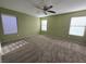 Spacious bedroom has neutral carpet, ceiling fan, and three windows for plenty of natural light at 11763 Village Arbor St, Las Vegas, NV 89183