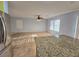 Open-concept living room features tile floors, ceiling fan, and natural light at 11763 Village Arbor St, Las Vegas, NV 89183
