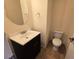 Powder room with dark wood vanity, single sink, and toilet at 11763 Village Arbor St, Las Vegas, NV 89183