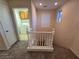 Second-floor landing with carpeted floors and access to the laundry room at 11763 Village Arbor St, Las Vegas, NV 89183