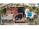 Aerial view of a luxury home with a tile roof, solar panels, a sparkling pool, and lush landscaping at 18 Grand Corniche Dr, Henderson, NV 89011