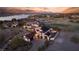 Breathtaking aerial view of a luxurious home with a red tile roof, pool, and stunning sunset views at 18 Grand Corniche Dr, Henderson, NV 89011