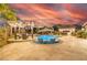 Beautiful pool with lounge chairs in the water and outdoor kitchen and dining area with mountain views at 18 Grand Corniche Dr, Henderson, NV 89011