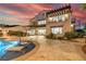This luxurious backyard features a pool, spa, patio, outdoor kitchen, spiral staircase, and impeccable landscaping at 18 Grand Corniche Dr, Henderson, NV 89011