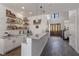 Custom bar featuring granite countertops, open shelving, and stylish pendant lighting at 18 Grand Corniche Dr, Henderson, NV 89011