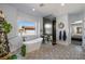 Serene bathroom featuring a standalone tub, stylish tile flooring, and modern fixtures at 18 Grand Corniche Dr, Henderson, NV 89011