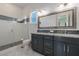 Bright bathroom with dual sinks, updated tile, and walk in shower at 18 Grand Corniche Dr, Henderson, NV 89011