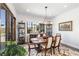Elegant dining room featuring a wooden table, decorative rug, and bright natural light at 18 Grand Corniche Dr, Henderson, NV 89011
