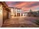 A three car garage is situated on a large, paved driveway in front of this lovely home at 18 Grand Corniche Dr, Henderson, NV 89011