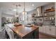 Gourmet kitchen with oversized island, modern appliances, and custom lighting at 18 Grand Corniche Dr, Henderson, NV 89011