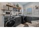 Well-organized laundry room features modern washer and dryer, sink, shelving, and storage for efficient chores at 18 Grand Corniche Dr, Henderson, NV 89011