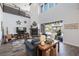 Bright living room features a fireplace, vaulted ceilings, and outdoor pool views at 18 Grand Corniche Dr, Henderson, NV 89011