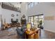 Spacious living room with high ceilings, a cozy fireplace, and seamless indoor-outdoor flow at 18 Grand Corniche Dr, Henderson, NV 89011
