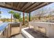 Modern outdoor kitchen with stainless steel appliances, custom countertops, and covered dining space at 18 Grand Corniche Dr, Henderson, NV 89011