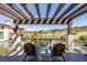 Relaxing patio with comfortable seating, pergola, and scenic golf course views at 18 Grand Corniche Dr, Henderson, NV 89011