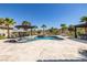 An inviting freeform pool featuring a spa, umbrellas, lounge chairs, and an outdoor kitchen at 18 Grand Corniche Dr, Henderson, NV 89011