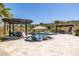 Resort style pool with integrated spa, lounge chairs, umbrellas, and covered outdoor seating at 18 Grand Corniche Dr, Henderson, NV 89011