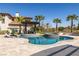 An amazing pool with integrated spa, lounge chairs, umbrellas, and covered outdoor seating at 18 Grand Corniche Dr, Henderson, NV 89011