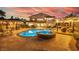 Inviting backyard oasis with a sparkling pool, hot tub, and outdoor kitchen perfect for entertaining at 18 Grand Corniche Dr, Henderson, NV 89011