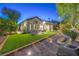 A manicured backyard with synthetic grass creating a stylish and low-maintenance outdoor living space at 1900 Vero Dr, Las Vegas, NV 89134