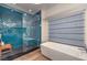 Contemporary bathroom featuring a standalone tub, and a glass shower with bright teal tile surround at 1900 Vero Dr, Las Vegas, NV 89134